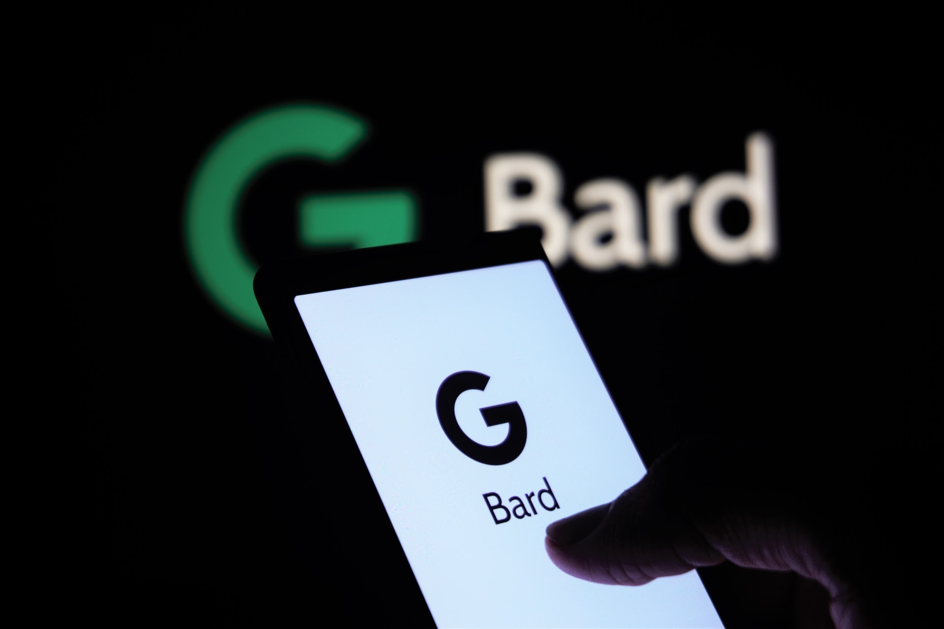 Google Bard & Person Holding Phone
